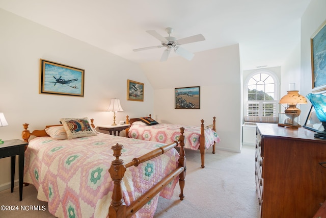 carpeted bedroom featuring ceiling fan and vaulted ceiling