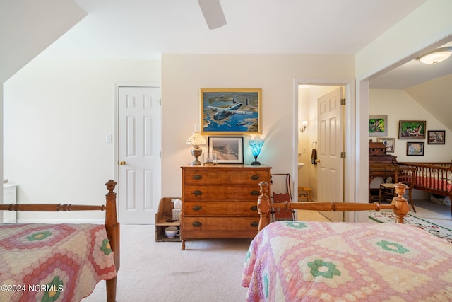 carpeted bedroom with ensuite bathroom, a closet, and ceiling fan