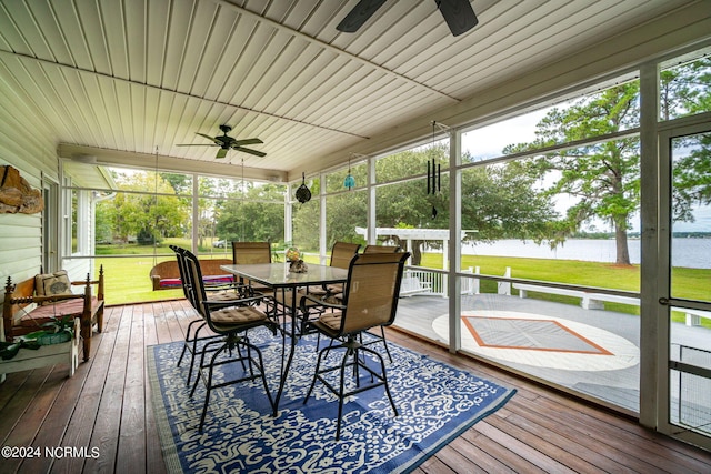 sunroom / solarium with a water view and ceiling fan