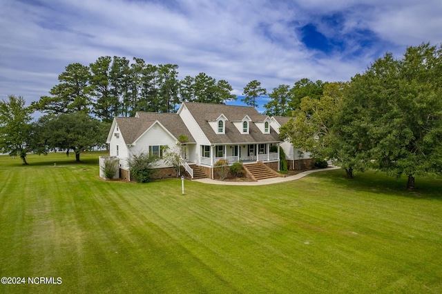 cape cod house with a porch and a front yard