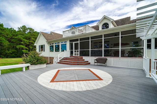 wooden deck featuring a sunroom