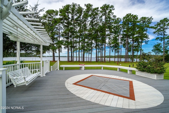 wooden deck featuring a yard and a water view