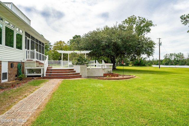 view of yard with a sunroom and a deck