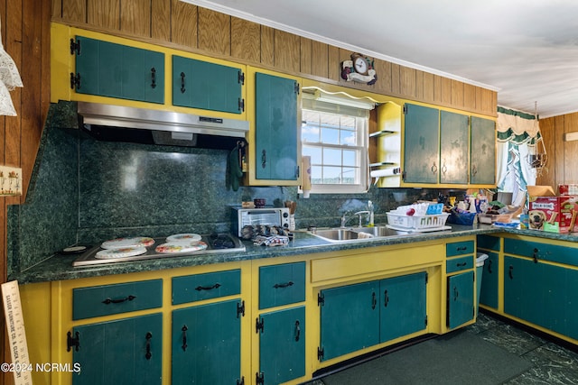 kitchen with cooktop, sink, tasteful backsplash, crown molding, and range hood