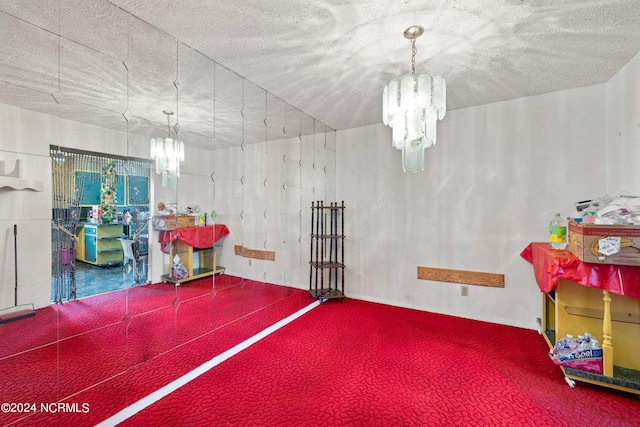 interior space with a chandelier and a textured ceiling