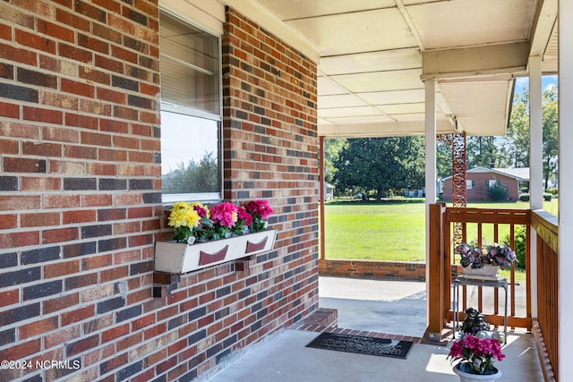 exterior space with covered porch and a lawn