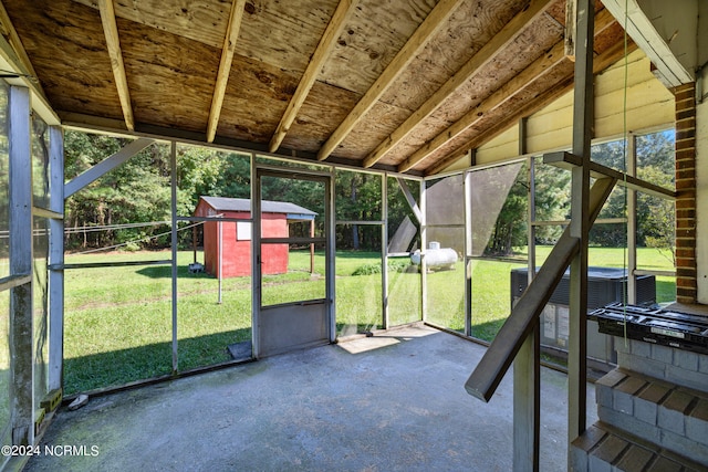 unfurnished sunroom featuring lofted ceiling