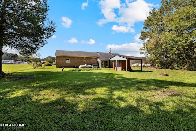 back of house with a lawn