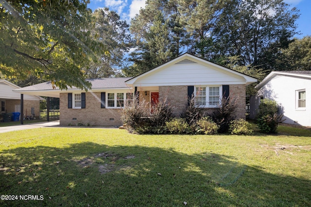 ranch-style home featuring a carport and a front yard