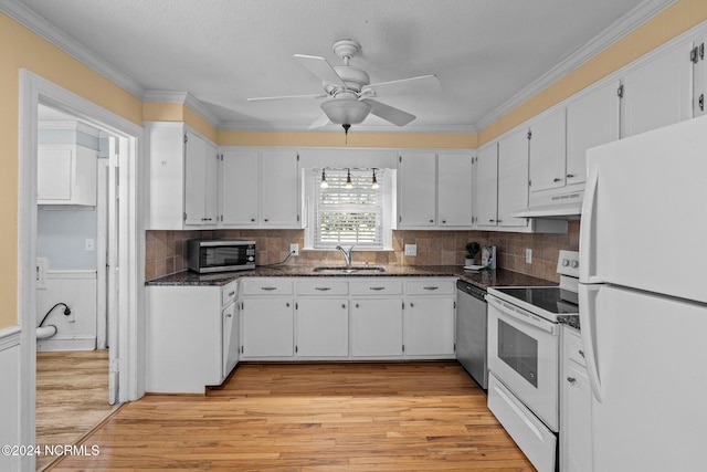 kitchen with appliances with stainless steel finishes, sink, and white cabinetry