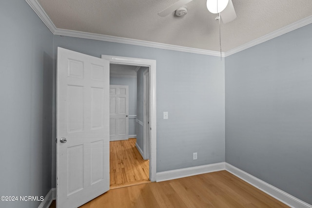 unfurnished room with ceiling fan, ornamental molding, hardwood / wood-style floors, and a textured ceiling