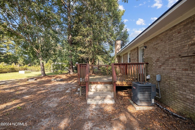 view of yard with cooling unit and a deck