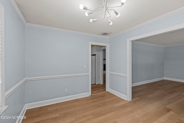 interior space with a notable chandelier, light wood-type flooring, and a textured ceiling