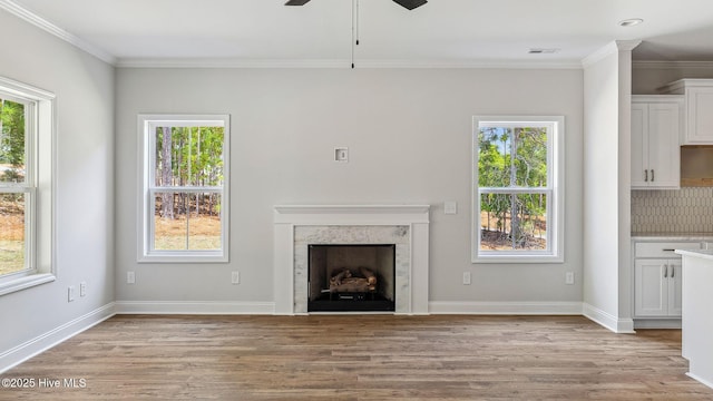 unfurnished living room featuring a wealth of natural light and a ceiling fan