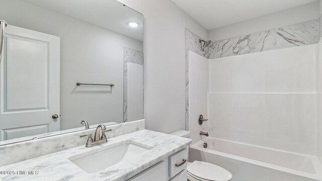 bathroom featuring toilet, vanity, and shower / bathtub combination