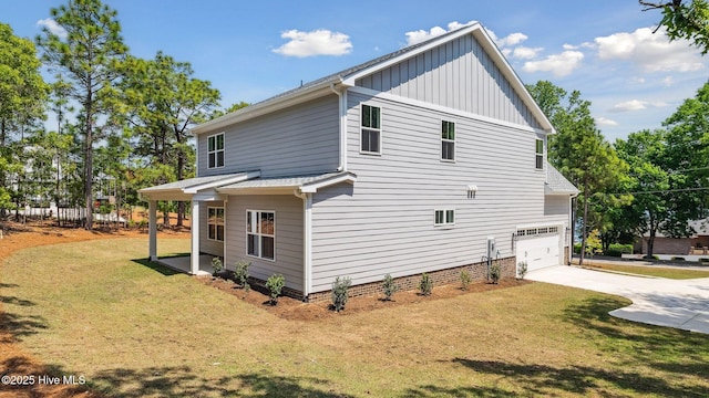 view of side of home featuring a lawn, board and batten siding, driveway, and a garage