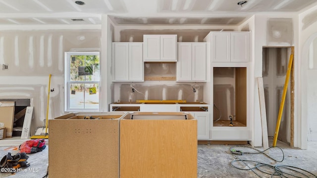 kitchen with white cabinets and backsplash