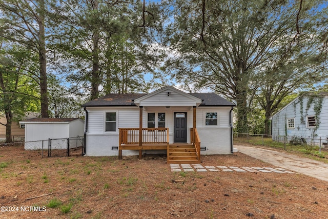 view of front of house featuring a storage shed