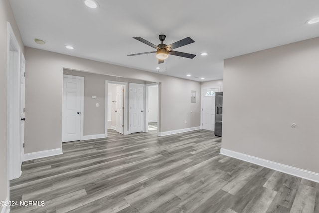 unfurnished living room with ceiling fan and light hardwood / wood-style flooring