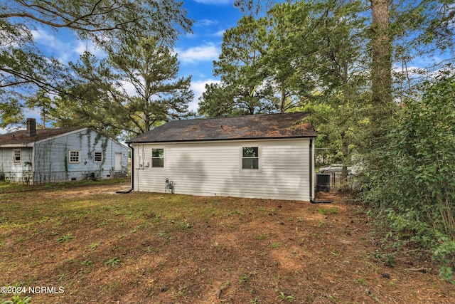 rear view of property with a lawn