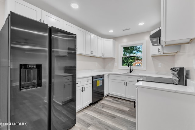 kitchen featuring stainless steel fridge, light wood-type flooring, electric range, dishwasher, and white cabinetry