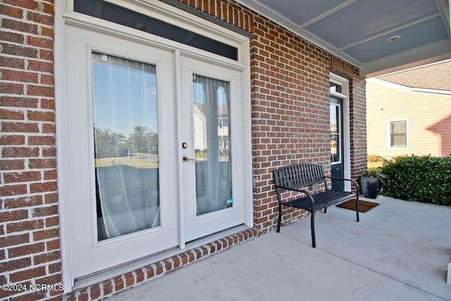 entrance to property with brick siding and french doors