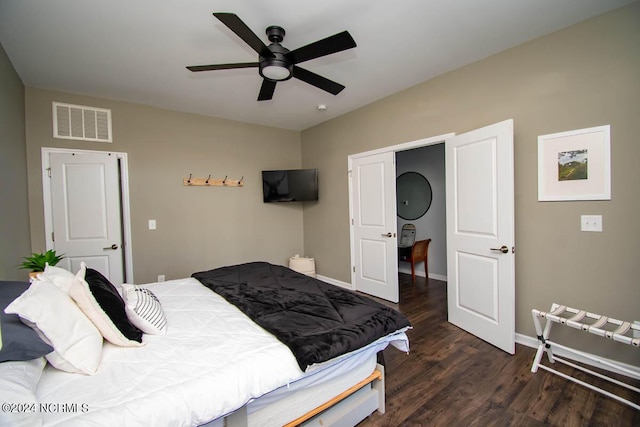 bedroom featuring ceiling fan, baseboards, visible vents, and wood finished floors