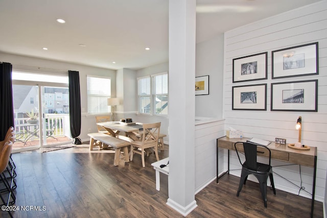 office with dark wood-type flooring and wooden walls