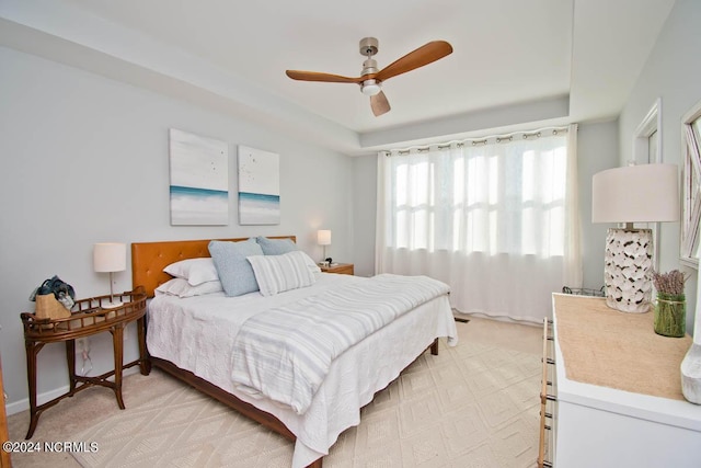bedroom with a ceiling fan and light colored carpet