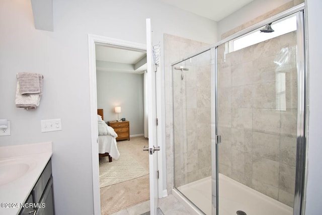 bathroom featuring a shower with door, vanity, and tile patterned floors