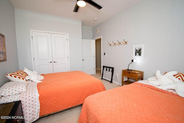 bedroom with ceiling fan, visible vents, baseboards, a closet, and light carpet