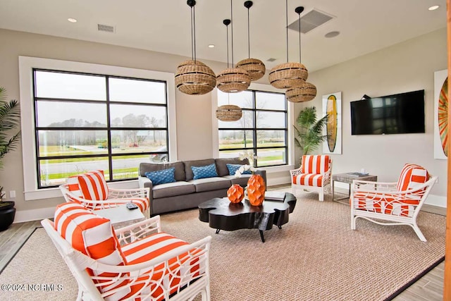 living room with recessed lighting, baseboards, visible vents, and wood finished floors