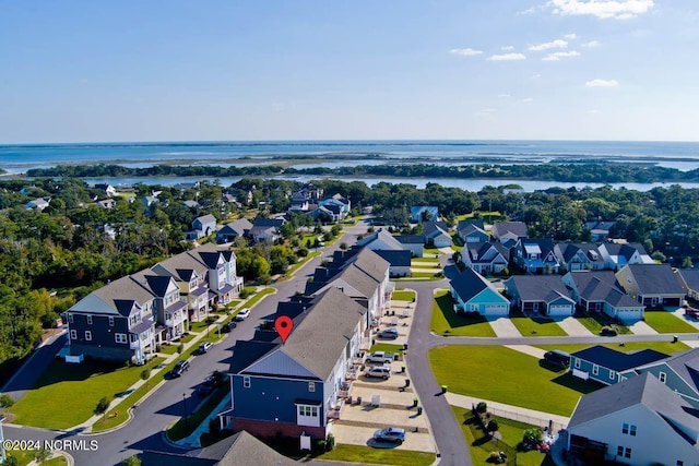 drone / aerial view featuring a water view and a residential view
