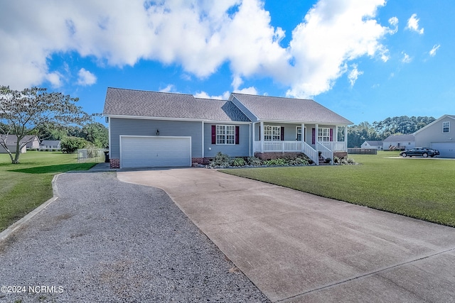 ranch-style home with covered porch, a front yard, and a garage