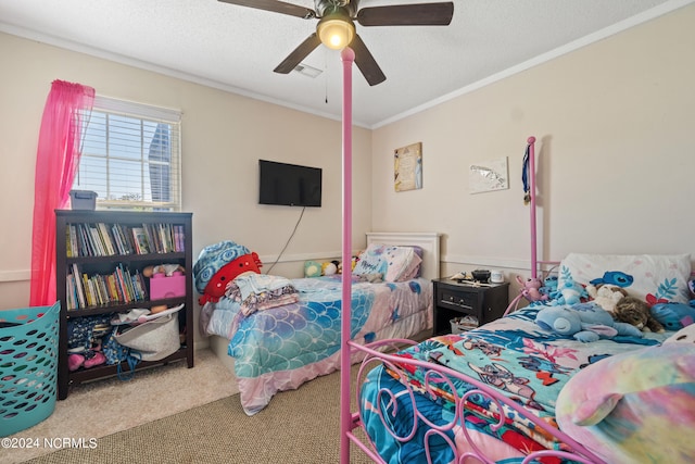 carpeted bedroom featuring ceiling fan, crown molding, and a textured ceiling