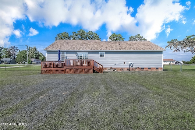 rear view of house with a yard and a deck