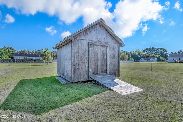 view of outbuilding with a yard