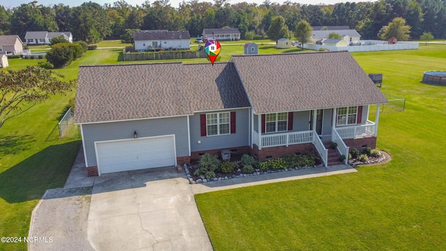 view of front of home featuring a porch, a garage, and a front lawn