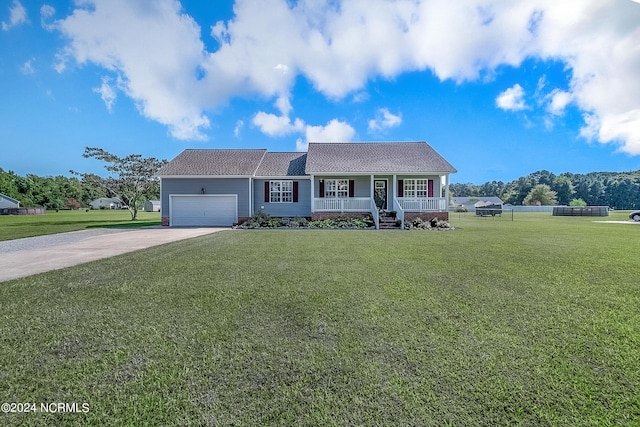 view of front of house with a front yard, a porch, and a garage