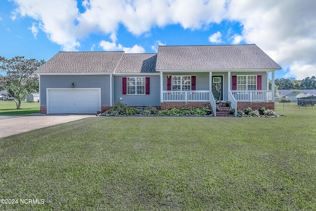 ranch-style home with covered porch, a garage, and a front yard