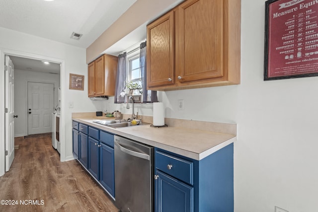 kitchen featuring stainless steel dishwasher, a textured ceiling, sink, washer / dryer, and dark hardwood / wood-style floors