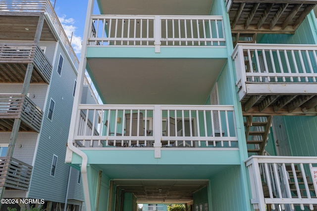 view of side of home featuring a balcony