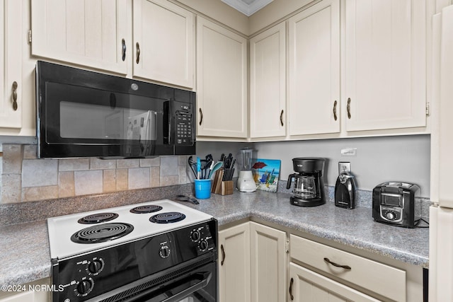 kitchen featuring decorative backsplash, cream cabinetry, and electric range