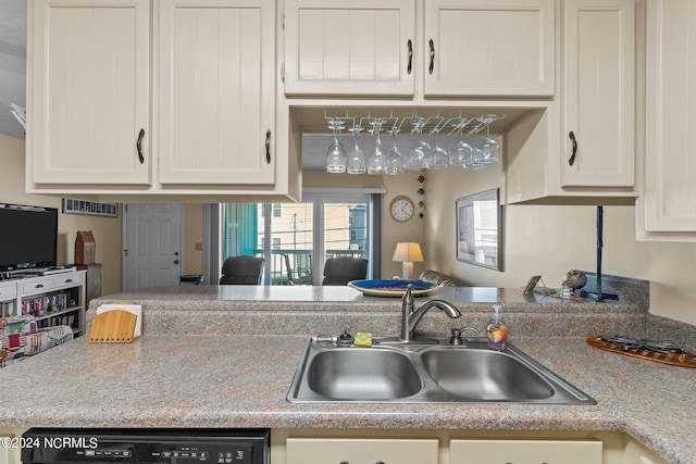 kitchen with dishwasher, sink, and white cabinetry