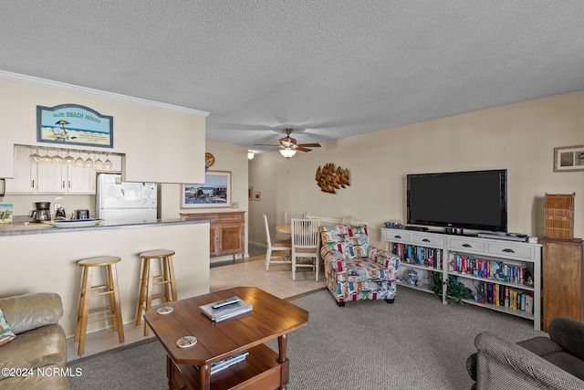 carpeted living room featuring crown molding, a textured ceiling, and ceiling fan