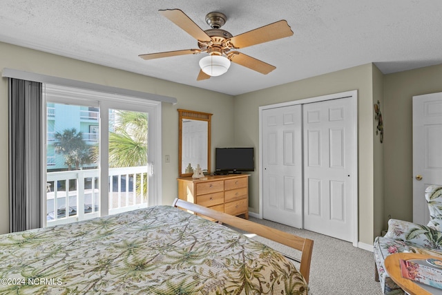 carpeted bedroom featuring ceiling fan, a textured ceiling, and access to exterior