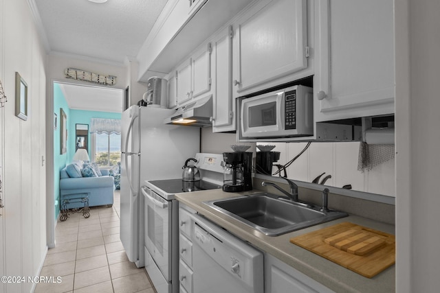 kitchen with white cabinets, light tile patterned flooring, sink, white appliances, and crown molding