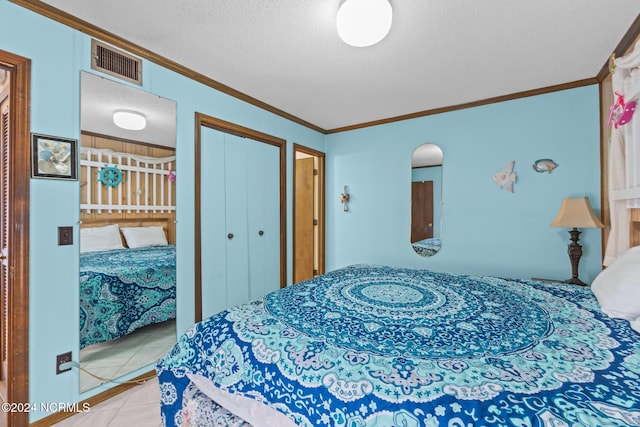 tiled bedroom featuring crown molding and a textured ceiling