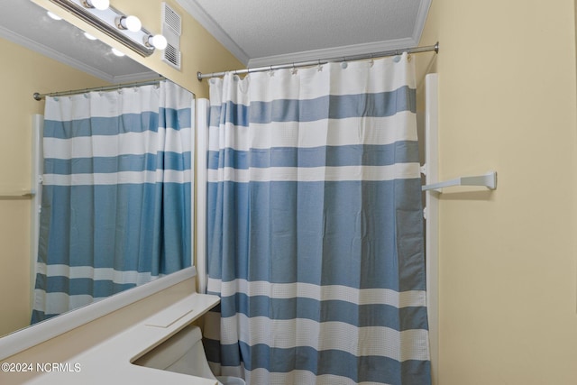 bathroom with walk in shower, a textured ceiling, and ornamental molding