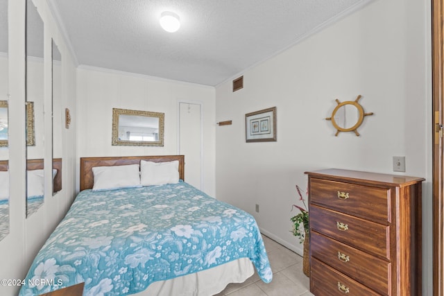 tiled bedroom featuring a textured ceiling and crown molding